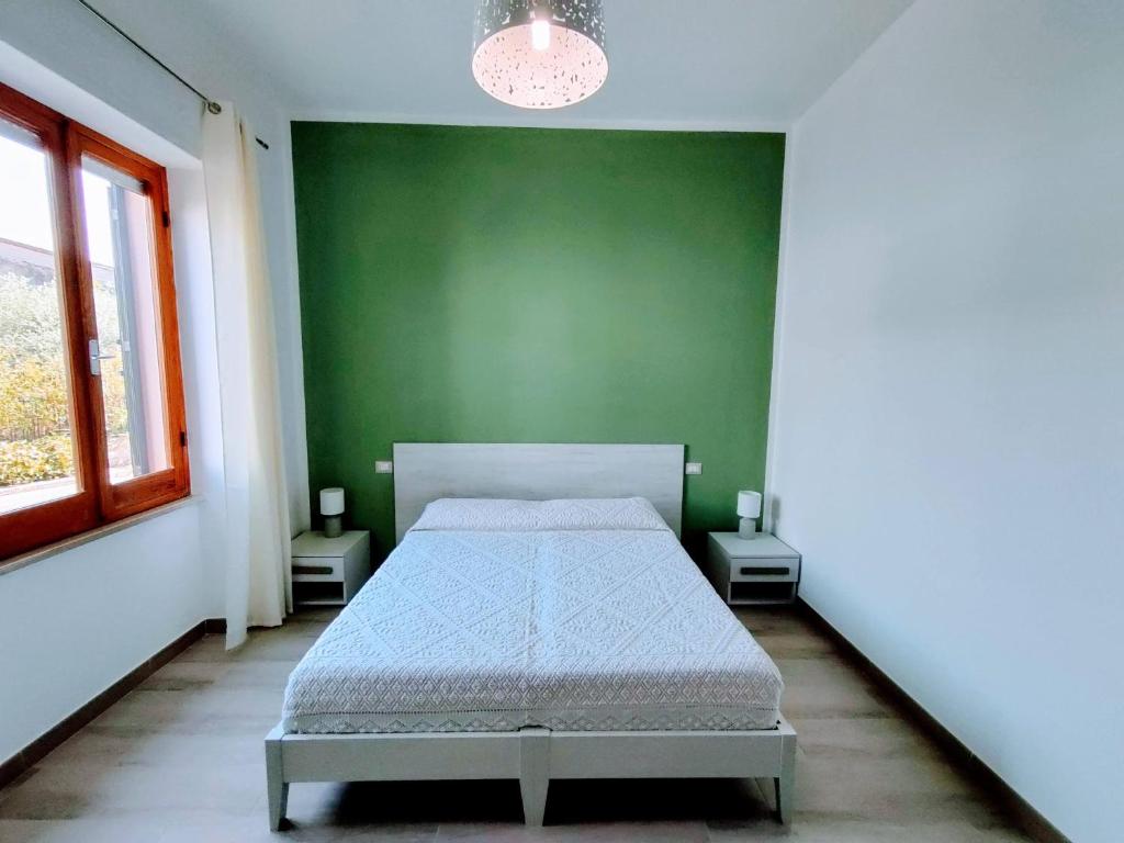 A bed or beds in a room at Sa Banita affittacamere