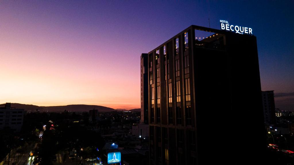 a building with a sign on the top of it at Becquer Hotel Guadalajara in Guadalajara