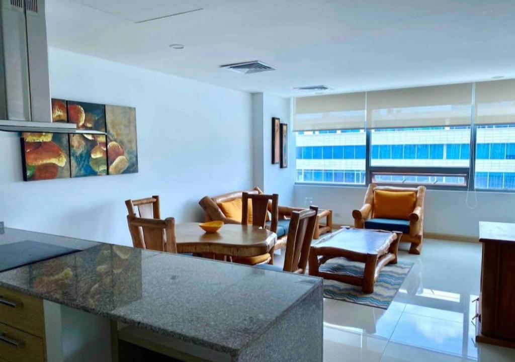 cocina y sala de estar con mesa y sillas en Apartamento en Blue Gardens familiar Barranquilla, en Barranquilla