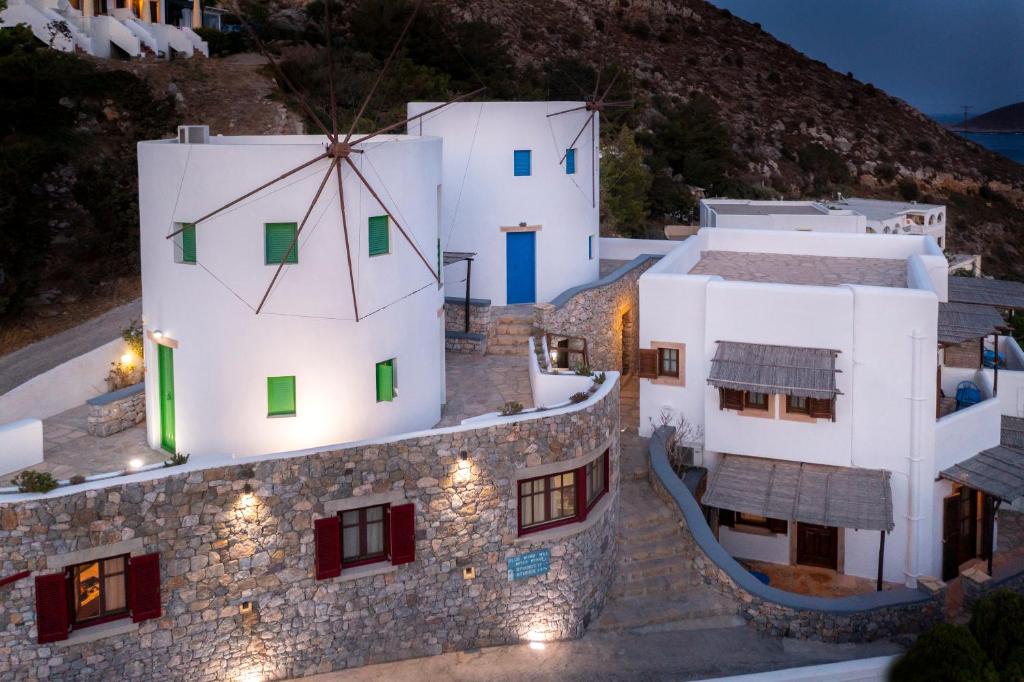 a group of white buildings with lights on them at Anemos Studios in Panteli