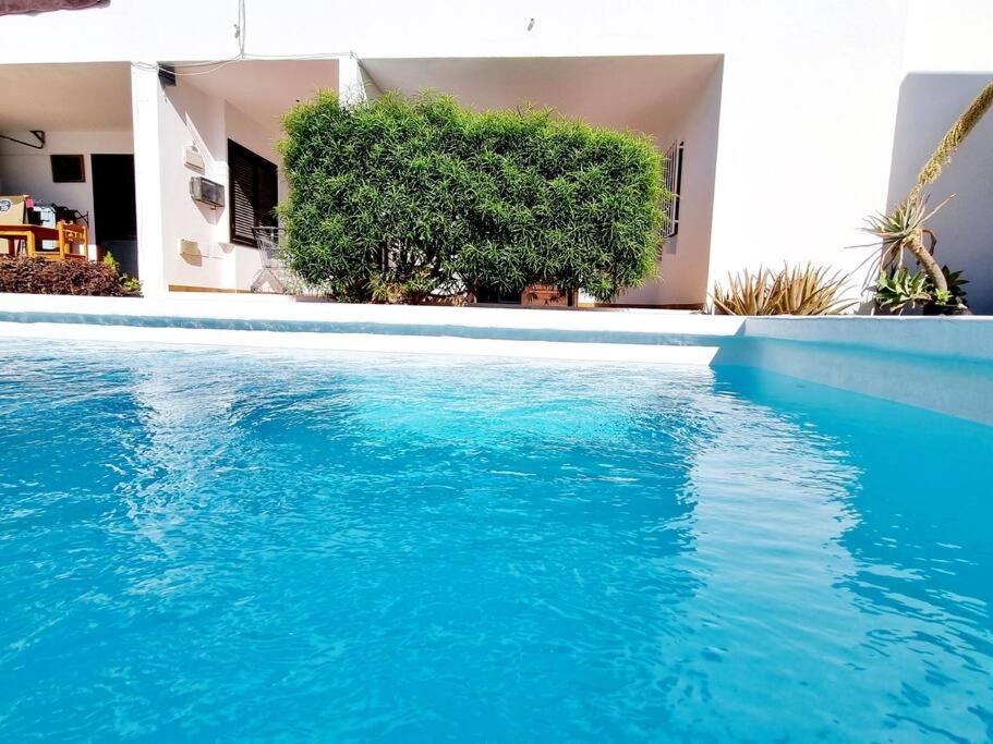 een blauw zwembad voor een huis bij Casa Jardon Puerto del Carmen in Puerto del Carmen