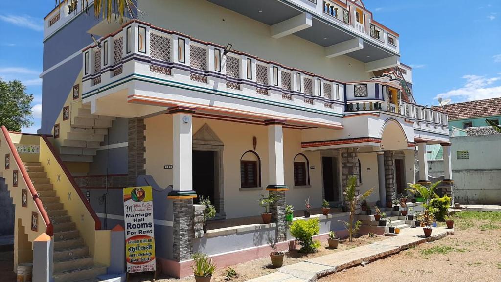 a building with a balcony on top of it at Mithila Eco Stay - Explore chettinad in Mithilaipatti