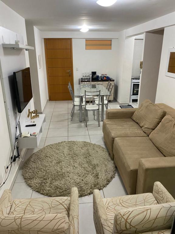 a living room with a couch and a table at Apartamento 2 quartos West Flat in Mossoró