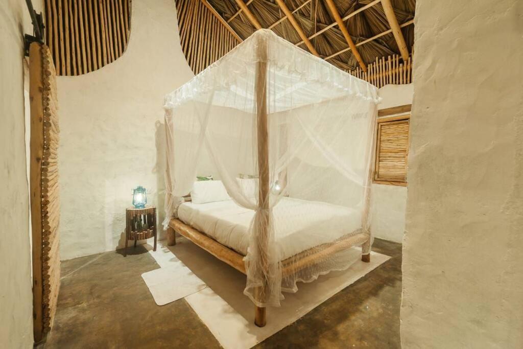 a bedroom with a bed with a canopy at Ella Retreat Cottage for Nature Lovers in Ella