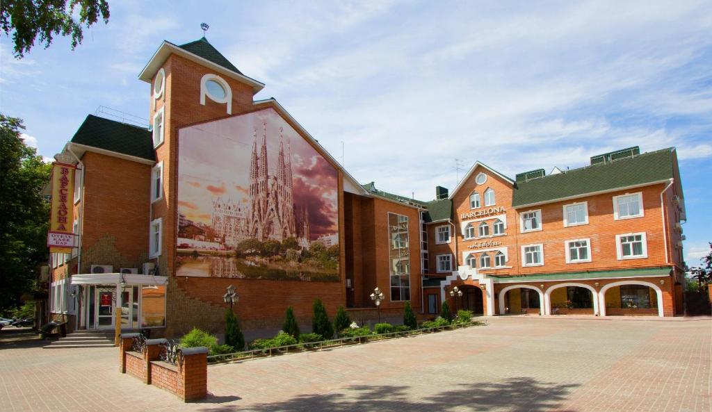 a building with a large mural on the side of it at Barcelona Spa-Hotel in Ulyanovsk
