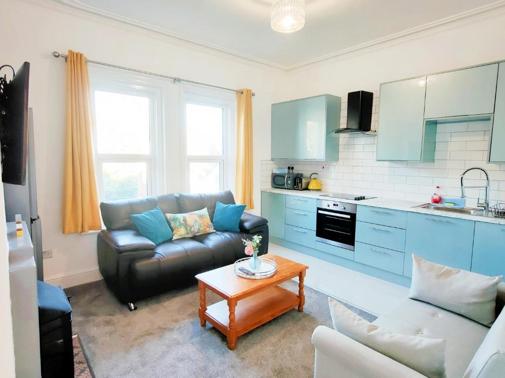 a living room with a couch and a table at C-New Flat,4 Adults,20 mins to Beach,Netflix,Wifi in Bournemouth