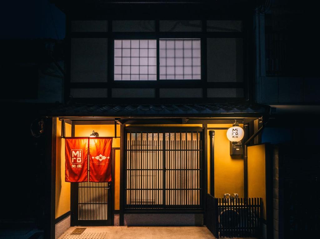 a building with a door with a sign on it at Miro Kyoto Shichjo Hanabatakecho Tei in Kyoto