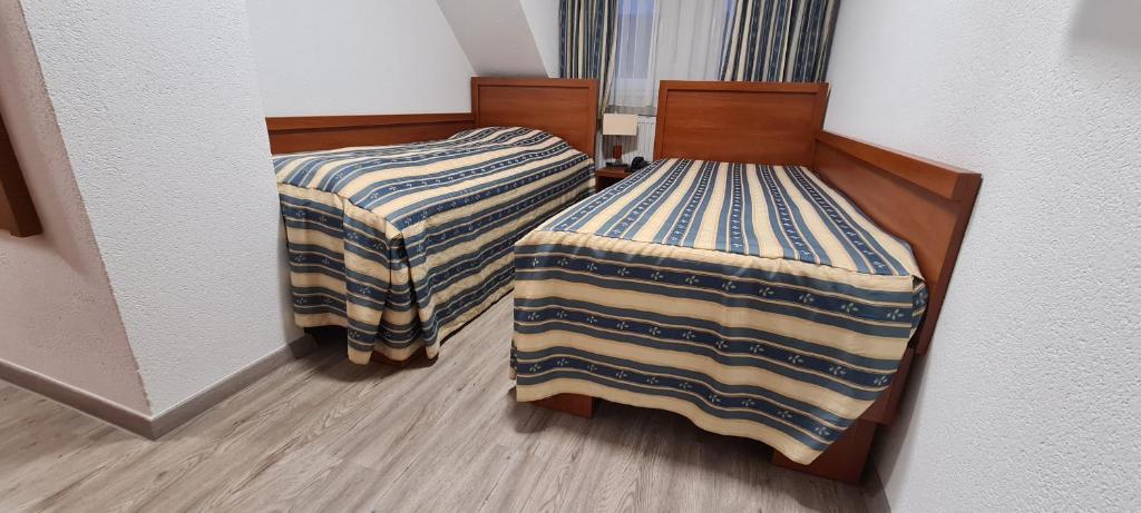 Postel nebo postele na pokoji v ubytování M-A-S-Hotel
