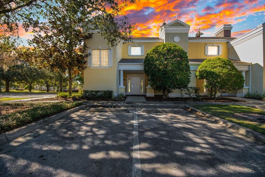 a large house with a driveway in front of it at ELEGANT, COMFORTABLE, INEXPENSIVE... REUNION RESORT in Kissimmee