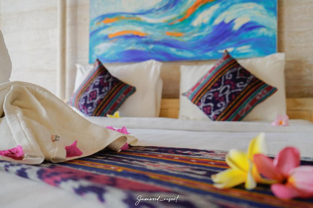 a bedroom with a bed with flowers on it at Java Wood in Gili Trawangan