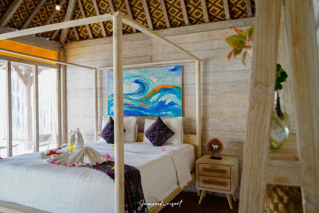 a bedroom with two beds and a painting on the wall at Java Wood in Gili Trawangan