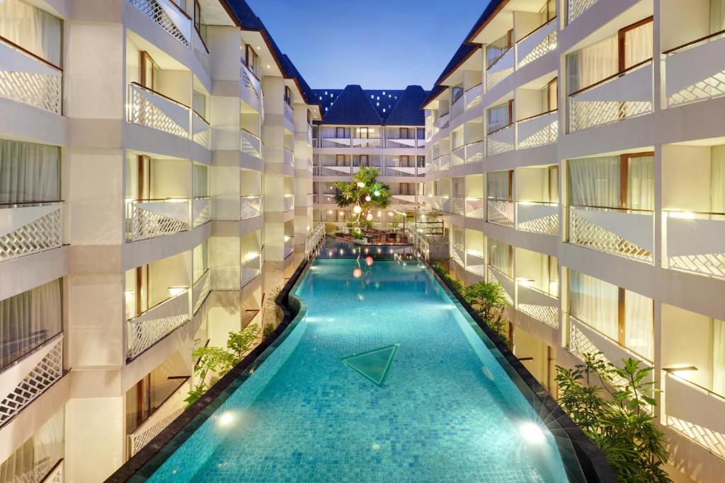 an overhead view of a swimming pool between two buildings at Episode Kuta Bali in Kuta