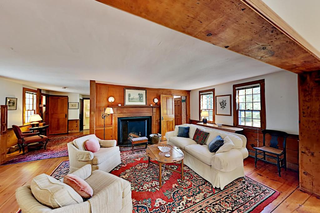 a living room with two couches and a fireplace at Beautiful Oceanside House in Falmouth