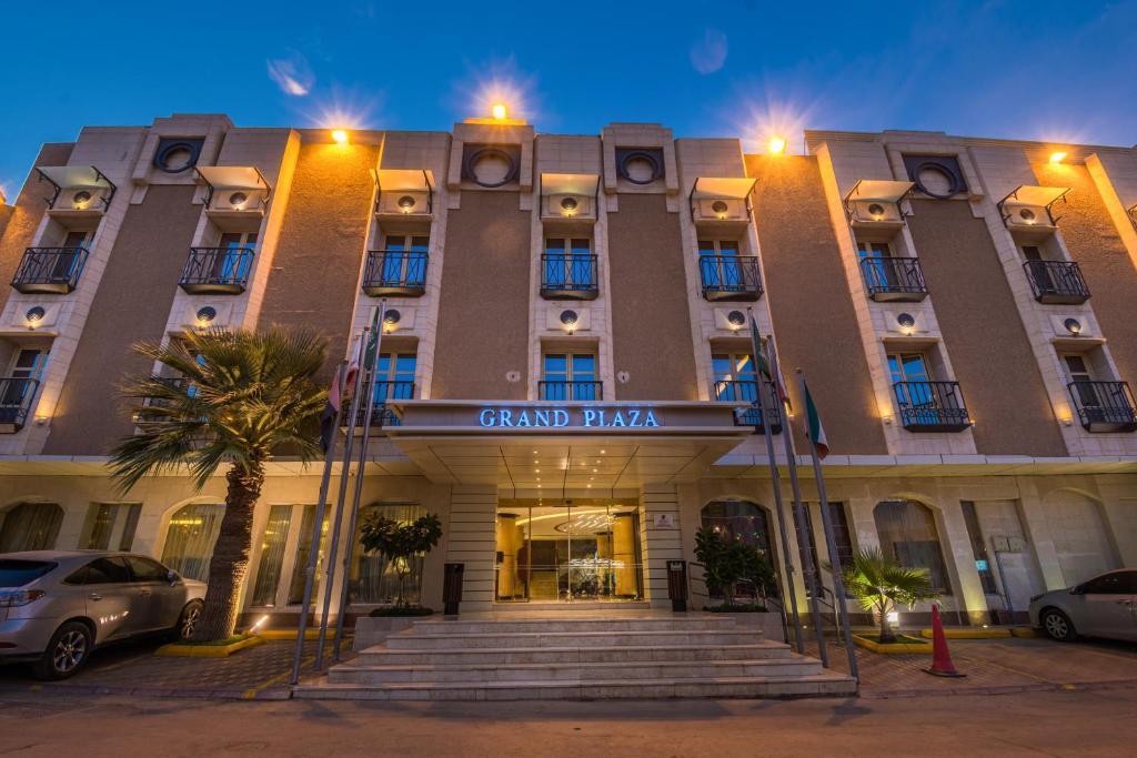 a grand plaza building with stairs in front of it at Grand Plaza Hotel - Takhasosi Riyadh in Riyadh