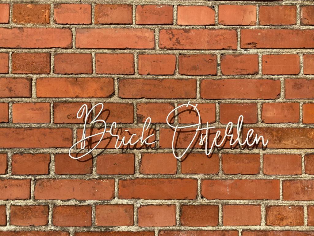 a brick wall with a sign that reads brick appreciation at BRICK Österlen in Simrishamn