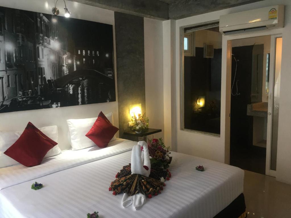 a bedroom with two beds with christmas decorations on them at The Front Hotel and Apartments in Patong Beach