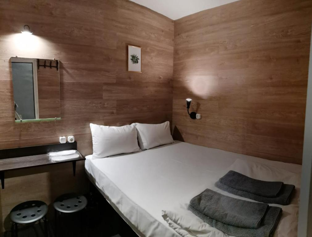 a bedroom with a large white bed with a mirror at SHELTERZ Электрозаводская in Moscow