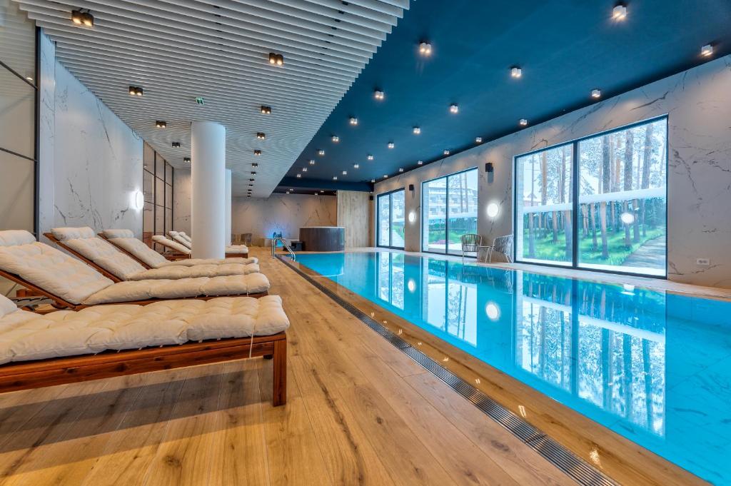a swimming pool in a house with a large room with a swimming pool at Konak Apartmani & SPA in Zlatibor