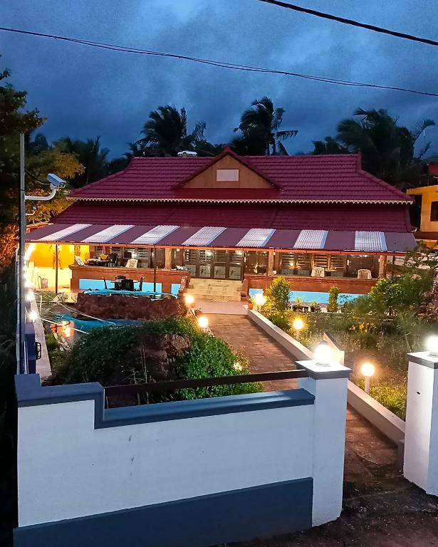 a view of a hotel at night at Beach Nest in Kannur