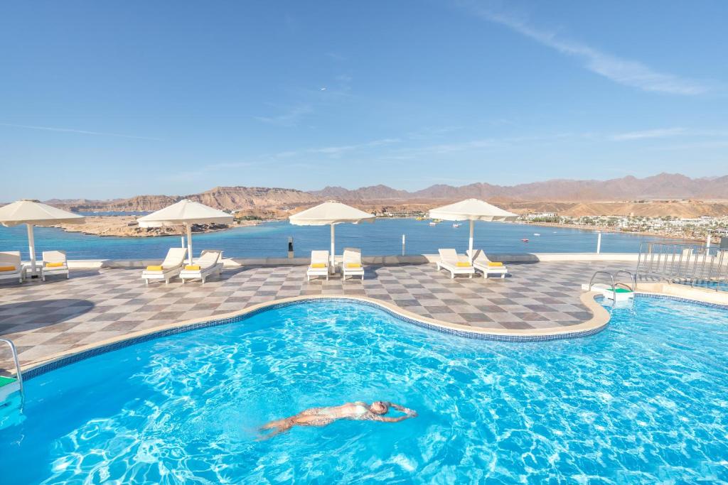 a person swimming in a swimming pool at Albatros Sharm Resort - By Pickalbatros in Sharm El Sheikh
