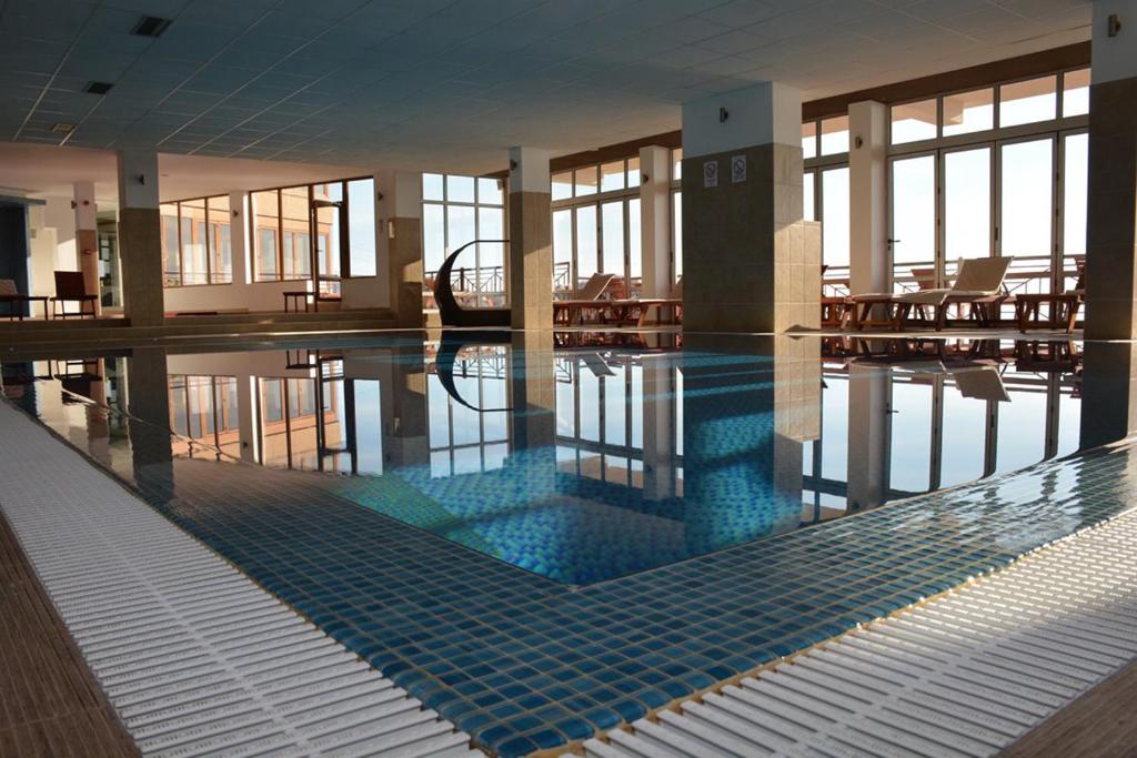 a swimming pool in a building with a pool at MILMARI CENTRAL Private apartments in Kopaonik