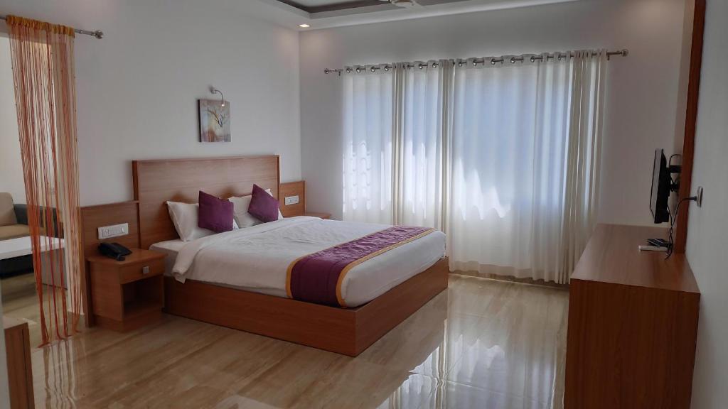Postel nebo postele na pokoji v ubytování Munnar Ice Queen Resorts