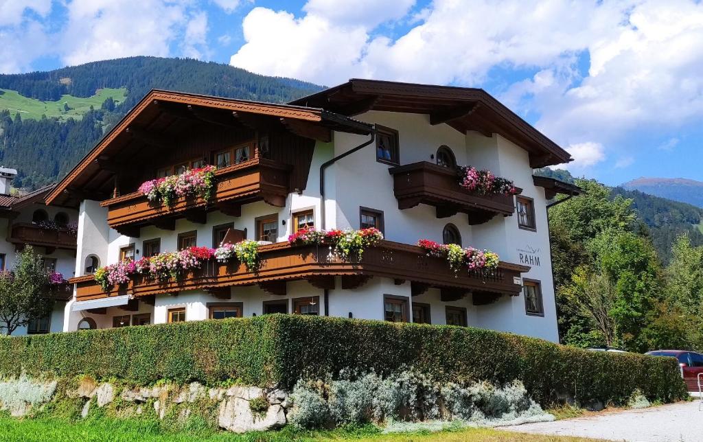 a building with flower boxes on the side of it at Ferienwohnung Rahm in Schwendau