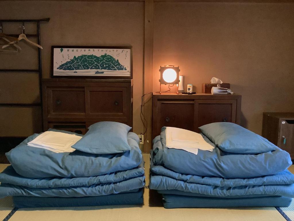 Postel nebo postele na pokoji v ubytování Onomichi Guest House Anago-no-Nedoko