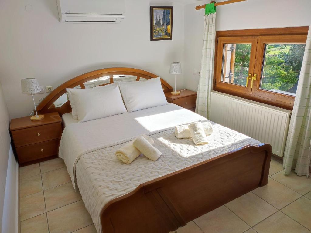 a bedroom with a bed with two towels on it at BAREFOOT COTTAGE in Skiathos Town