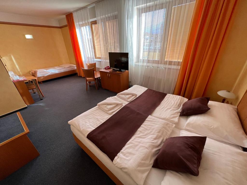 Postel nebo postele na pokoji v ubytování YURA hotel Čeladná BAZÉN A SAUNY ZDARMA