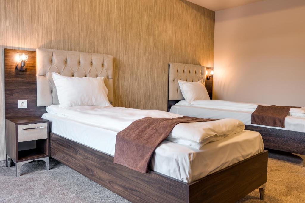 Postel nebo postele na pokoji v ubytování Family Hotel LILIUM