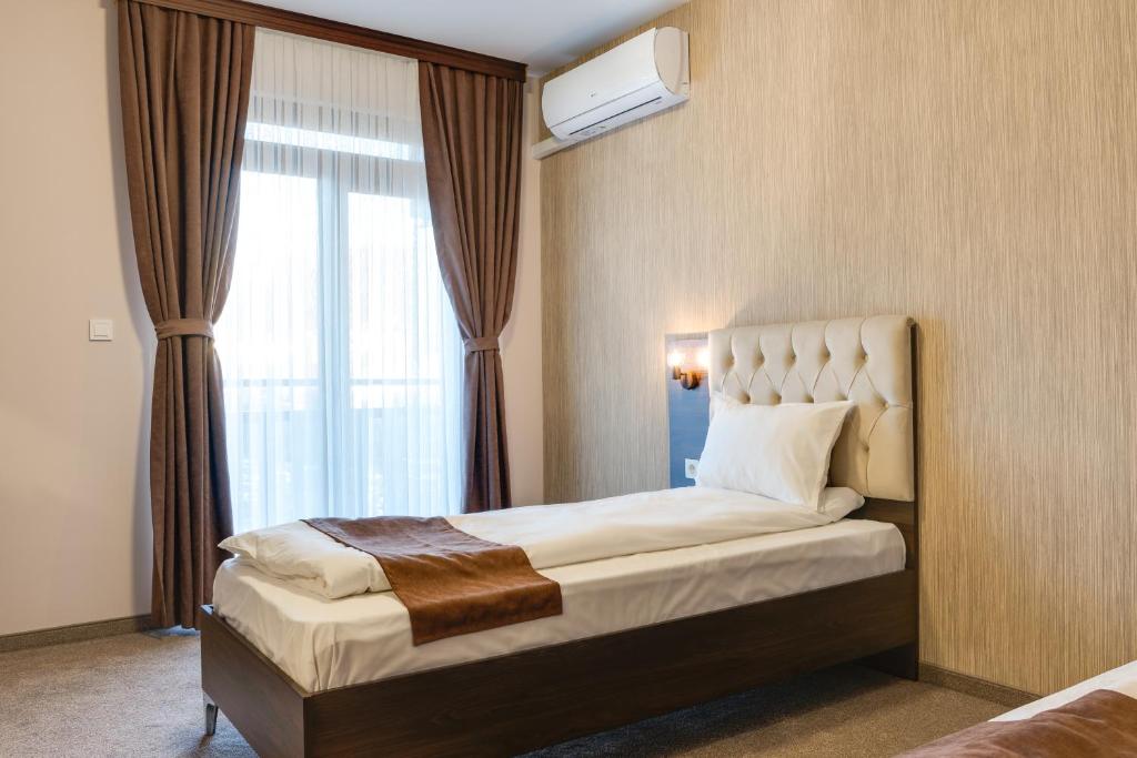 Postel nebo postele na pokoji v ubytování Family Hotel LILIUM
