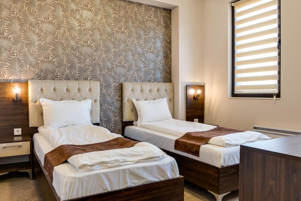 Postel nebo postele na pokoji v ubytování Family Hotel LILIUM