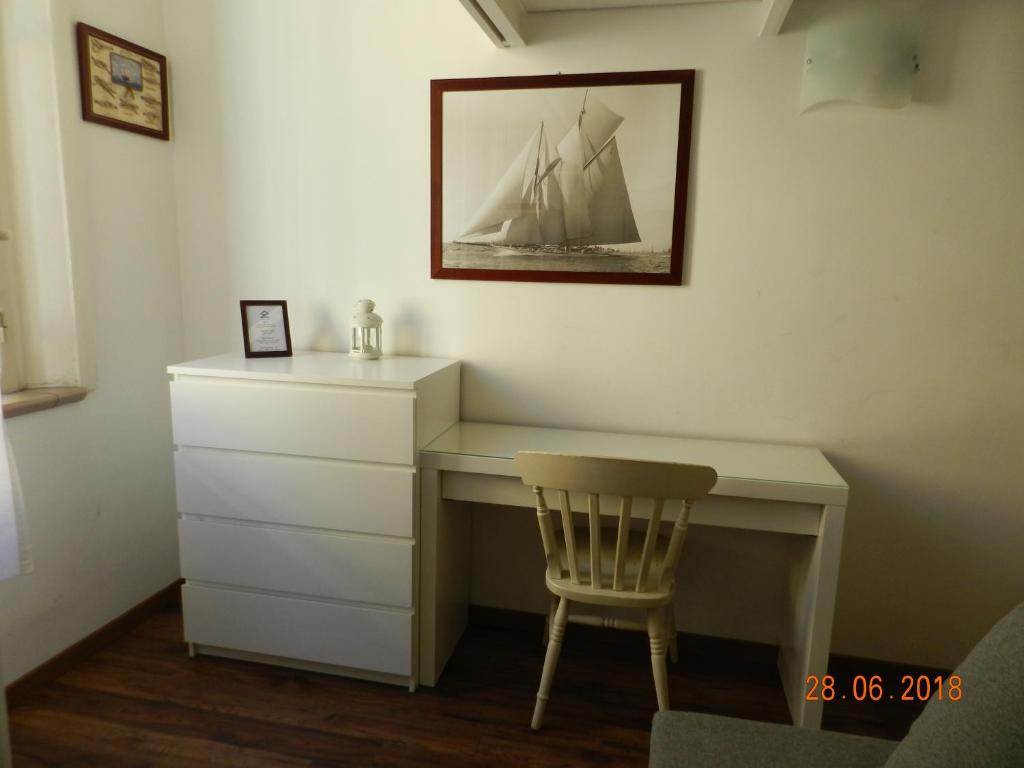 escritorio con silla y tocador en una habitación en Casa di Anna - monolocale centrale en Reggio Calabria