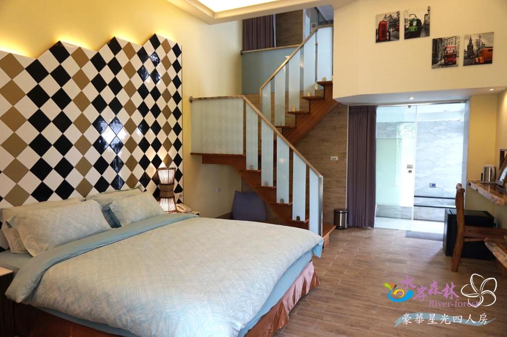 a bedroom with a large bed and a staircase at River Forest Leisure Farm in Dongshan
