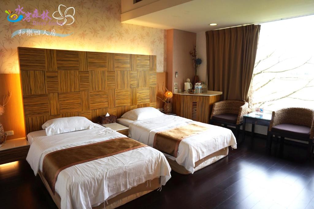 a hotel room with two beds and a window at River Forest Leisure Farm in Dongshan