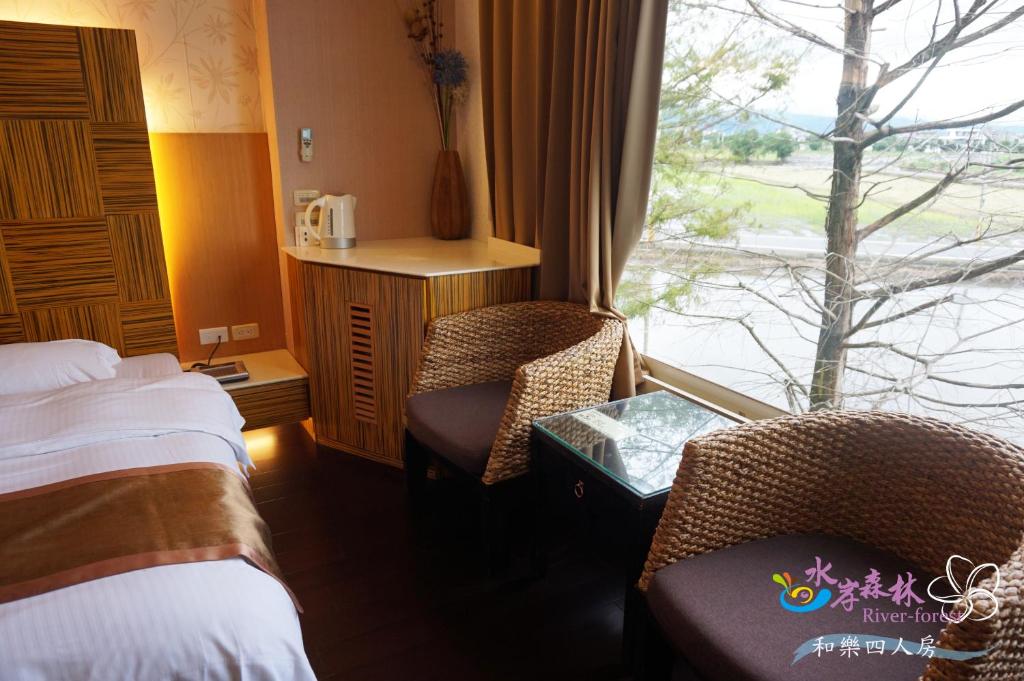 a hotel room with two beds and a window at River Forest Leisure Farm in Dongshan