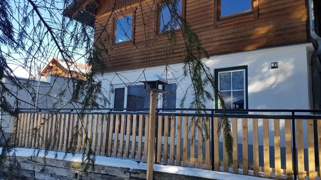 a house with a wooden fence in front of it at Apartment Katharina in Spital am Pyhrn