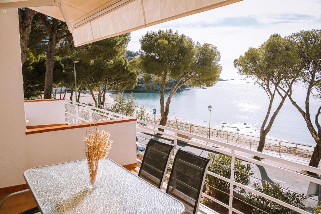 a dining room with a table and a view of the water at Agi Marina Apartments in Roses