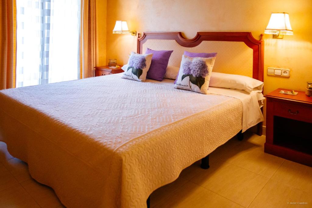 Postel nebo postele na pokoji v ubytování Hotel Avenida