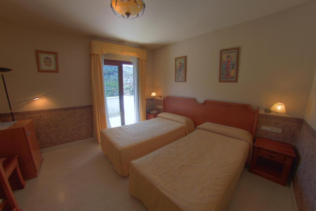 Postel nebo postele na pokoji v ubytování Hotel Avenida