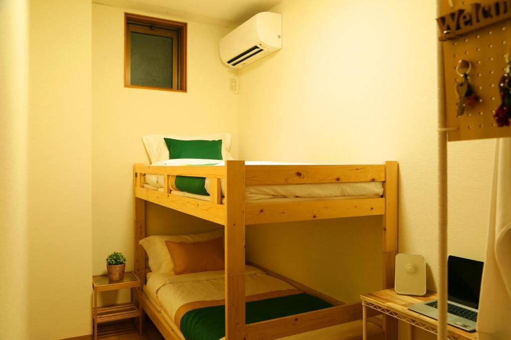Postel nebo postele na pokoji v ubytování E JOY INN-West Shinjuku Branch