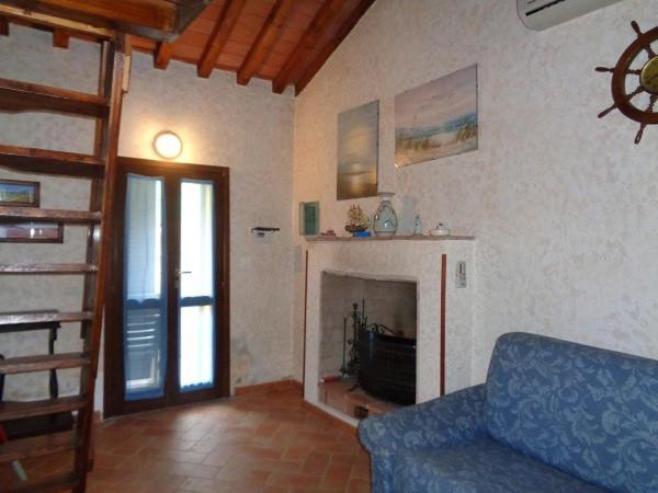 a living room with a couch and a fireplace at Casa Erty - Isola D'Elba in Rio nellʼElba