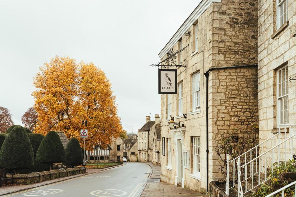 a clock on the side of a building on a street at The Falcon Inn in Painswick