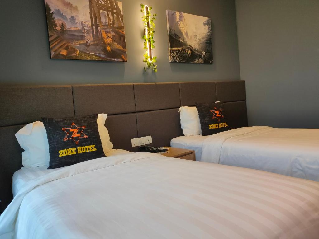 Postel nebo postele na pokoji v ubytování Zone Hotel Ipoh