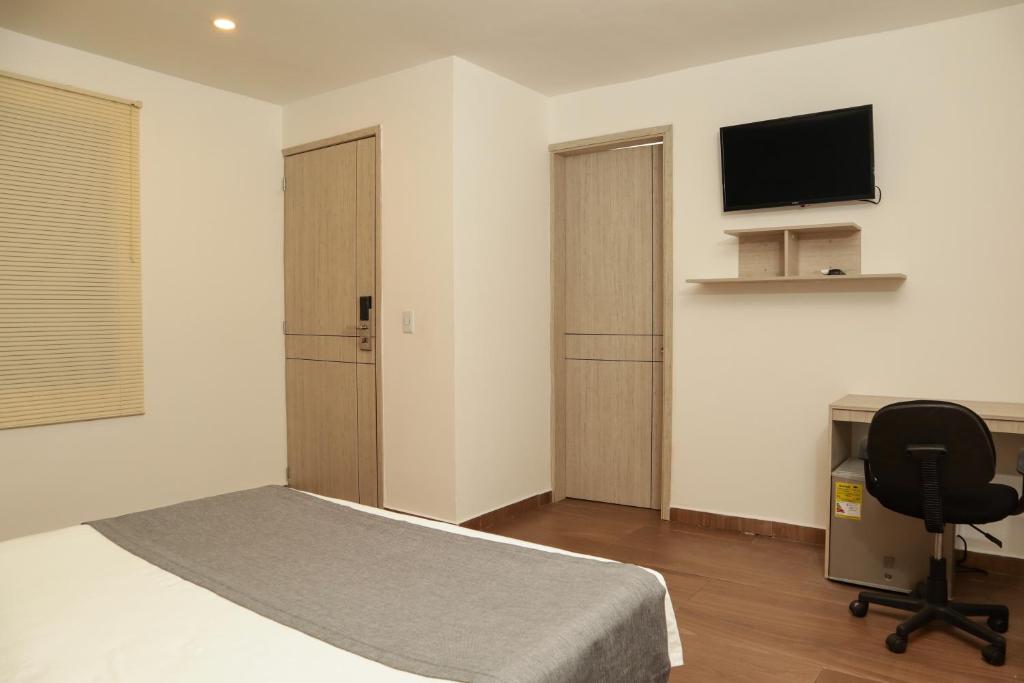 TV a/nebo společenská místnost v ubytování Diagonal Hotel Chipichape