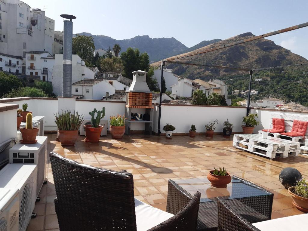 a patio with chairs and a fireplace on a roof at Casa Viola De Cazorla in Cazorla