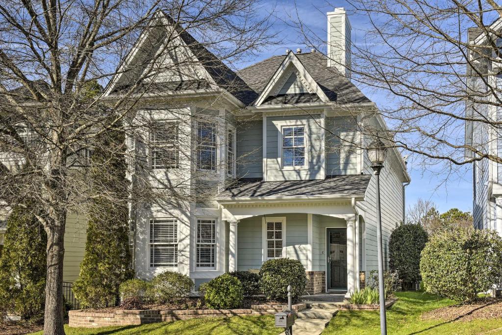 a white house with a gray roof at Lovely Morrisville Home with Patio and Gas Grill! in Durham