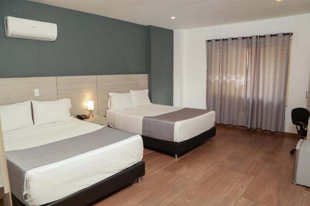 Postel nebo postele na pokoji v ubytování Diagonal Hotel Chipichape