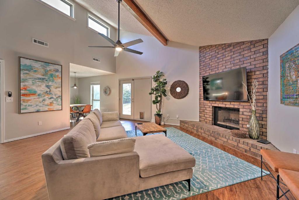 a living room with a couch and a fireplace at Modern Fayetteville Home Less Than 1 Mi to U of A! in Fayetteville